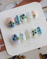 Blue Grid press-on nail set with raised berry details and breezy shirt-inspired plaid