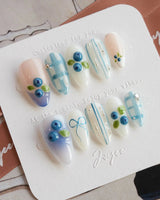 Blue Grid extra short almond press-on nails with crisp blue plaid and blueberries