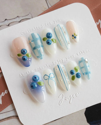 Blue Grid extra short almond press-on nails with crisp blue plaid and blueberries