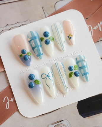 Blue Grid hand-sculpted blueberry nails with minimalist blue grid pattern