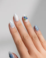 Blue Grid close-up of 3D blueberry charms on white and blue plaid nail art