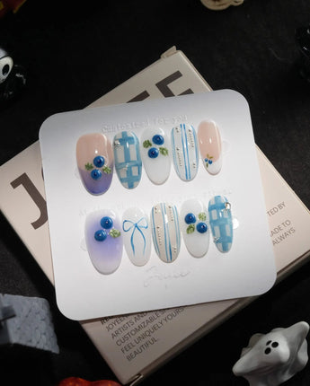 Blue Grid handmade press-on nails in medium oval shape by Joyee Nails
