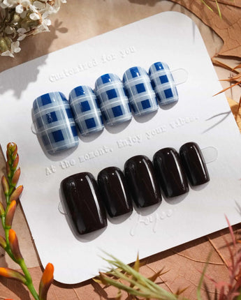 Fall-inspired plaid and solid black nails