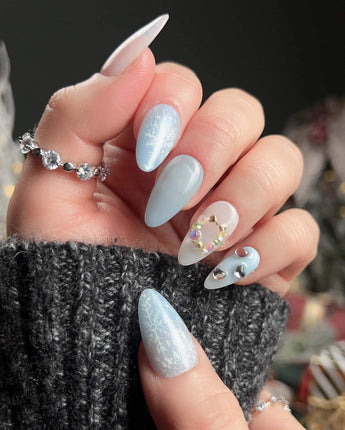Winter wonderland nail art close-up showing Icy Blue Snowflakes, Rhinestone Wreath & Hearts. details