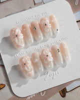 Blush Melt nude floral press-on nails with subtle aurora cat-eye finish