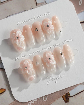 Blush Melt nude floral press-on nails with subtle aurora cat-eye finish