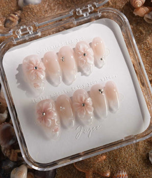 Blush Melt soft pink cat-eye nails with iced floral accents and glossy droplets