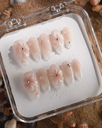 Blush Melt soft pink cat-eye nails with iced floral accents and glossy droplets