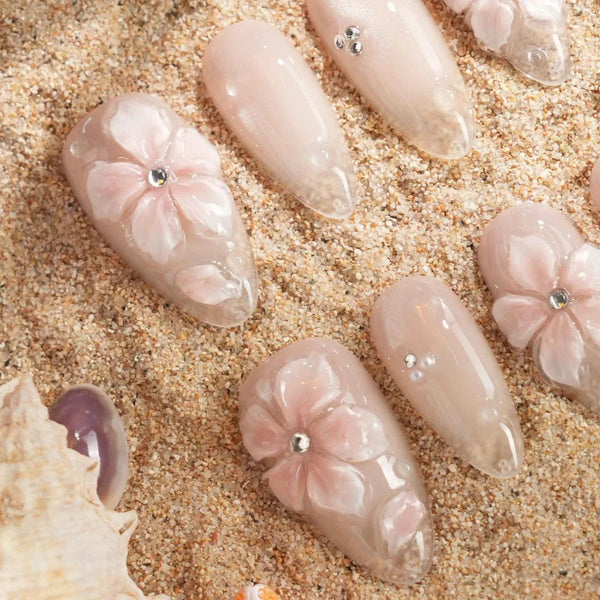 Blush Melt medium almond press-on nails with aurora nude cat-eye shimmer and translucent flowers