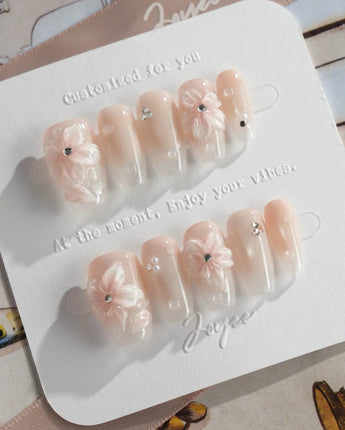 Blush Melt glossy summer press-on nails with pink cat-eye and clear petal accents