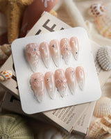 Blush Melt medium stiletto press-on nails with soft cat-eye shimmer and flowers