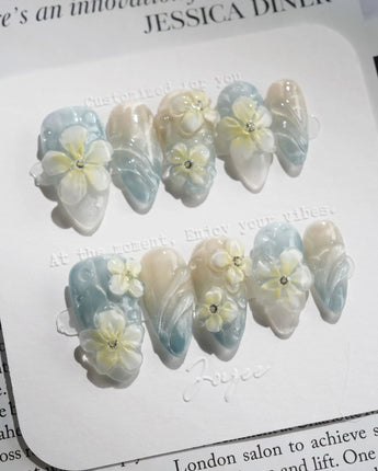 Bora Bora Blue serene ocean nails with icy blue cat-eye shine and 3D florals