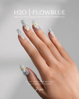 Bora Bora Blue medium coffin nails with smoky blue cat-eye waves and 3D plumeria flowers