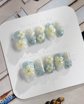 Bora Bora Blue short oval nails with luminous wave texture and sculpted tropical flowers