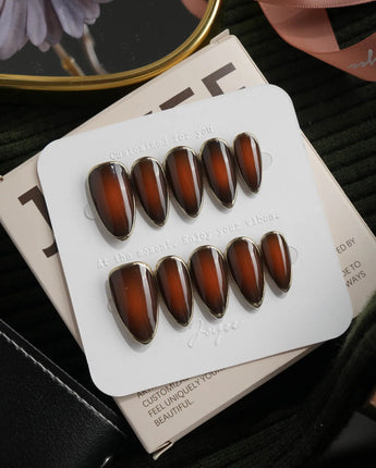 Bourbon press on nails in warm brown glossy jelly with a hand-drawn gold chrome outline - image 1