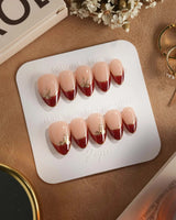 Bow French press-on nails — nude base red chrome french gold outline bow accent handmade nail art by Joyee Nails
