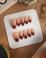 Bow French press-on nails — nude base red chrome french gold outline bow accent handmade nail art by Joyee Nails