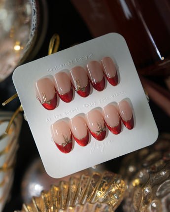 Bow French medium oval press-on nails with red chrome French tips and gold bow details