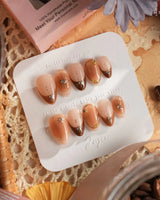 Fall Makeup press-on nails with brown gradient, gold wire stars, gems, and glossy autumn tones
