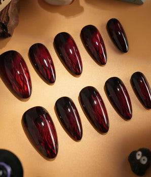 Burn handmade press-on nails featuring Dark Red Cat Eye, Flowing Flame Texture.