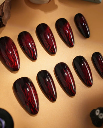 Burn handmade press-on nails featuring Dark Red Cat Eye, Flowing Flame Texture.