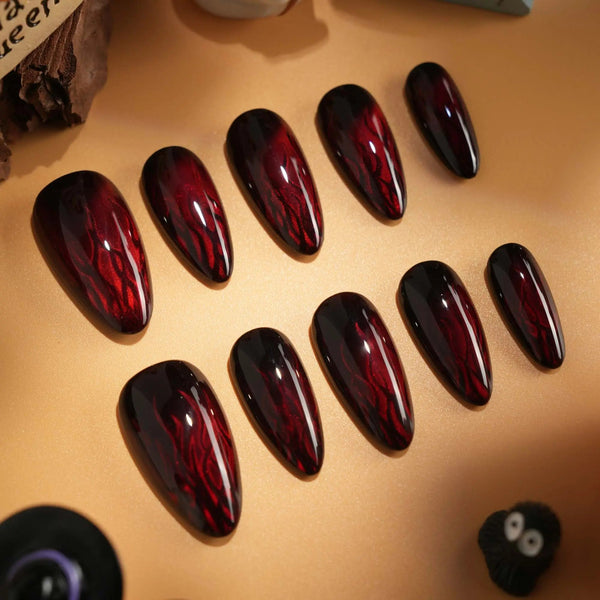 Burn handmade press-on nails featuring Dark Red Cat Eye, Flowing Flame Texture.
