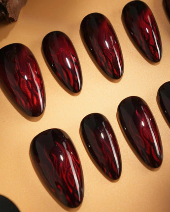 Burn nail art close-up showing Dark Red Cat Eye, Flowing Flame Texture. details