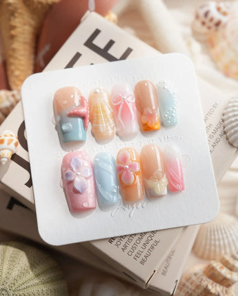 Candy Shore medium square nails with pastel sea elements, starfish, and florals