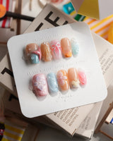 Candy Shore short coffin nails with pastel ocean charms and 3D starfish accents