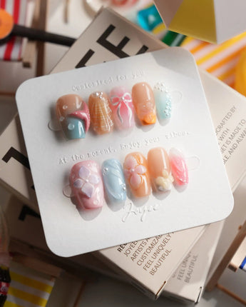 Candy Shore short coffin nails with pastel ocean charms and 3D starfish accents