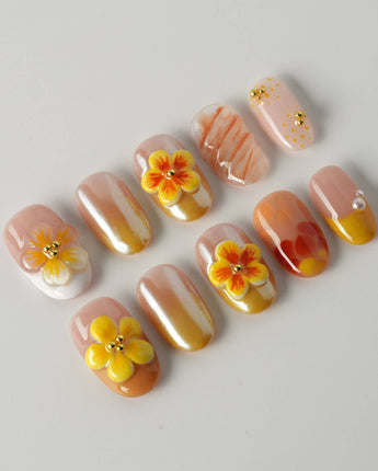 Caramel Bloom press-on nails in short oval with soft caramel tones and flower accents