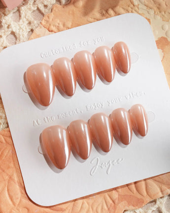 Caramel Chrome nails with soft nude brown color, chrome glow, and polished gel surface