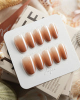 Caramel Chrome medium oval press-on nails with nude French tip styling with glossy gel finish