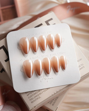 Caramel Chrome short stiletto press-on nails with nude French tip styling with glossy gel finish