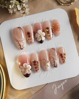 Caramel Cream press-on nails with caramel brown flowers and fine metallic linework