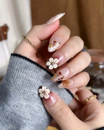 Caramel Cream press-ons with glossy caramel tones, raised floral details, and metallic gold lines