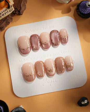 Caramel Petal press-on nails with glossy caramel nude base and rose-gold chrome accents