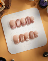 Caramel Petal press-on nails with nude base, mauve chrome French tips and ornate gold accents