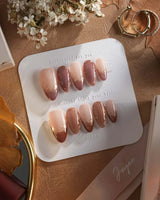 Caramel Petal press-on nails with rose chrome French tips, gold flourishes and soft nude base