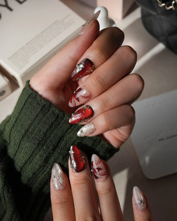 Carmine Court press on nails with sculpted gold leaves and silver pearls on deep red cat eye and a gold lattice on nude nails - image 5