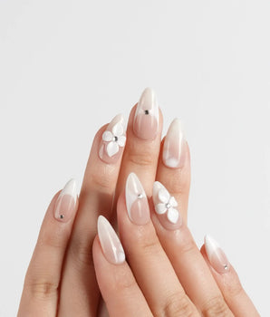 Ceramic handmade press-on nails featuring Classic Nude Pink Ombré, 3D White Florals & Minimalist Rhinestones.