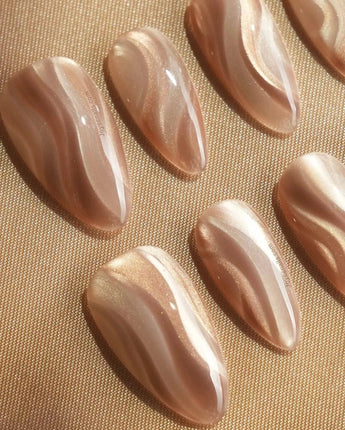 Champagne Ribbons handmade press-on nails featuring Champagne Nude Gold, Silky Cat-eye Textures & Streamlined Wave Luster.