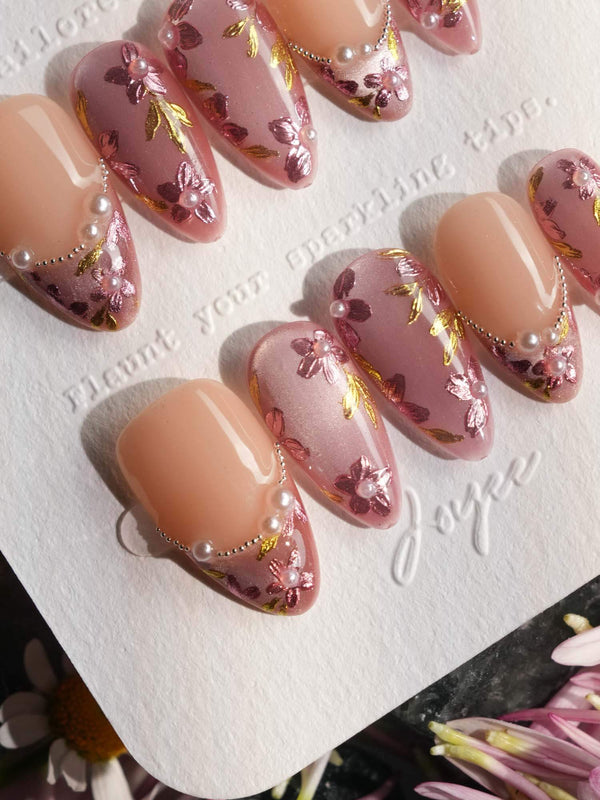 Cherry blossom press-on nails with gold leaf accents	