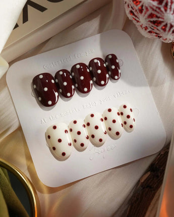 Choco Pop nail close-up with rich wine red color and creamy polka-dot contrast
