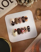 Chocolate Box press-on nails with realistic 3D chocolate pieces and handmade gel finish