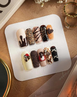 Chocolate Box press-on nails with raised cocoa-colored sweets and glossy handmade gel art