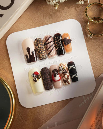 Chocolate Box press-on nails with raised cocoa-colored sweets and glossy handmade gel art