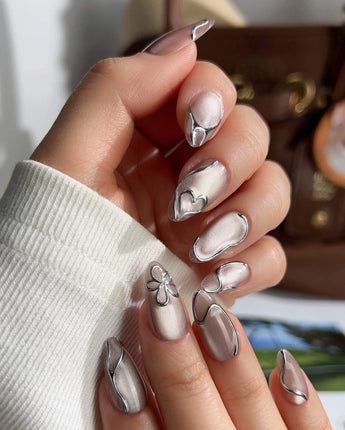 Chrome lines nail art close-up showing Cool-toned Silver Grey Cat Eye, Liquid Metal Lines & 3D Heart. details