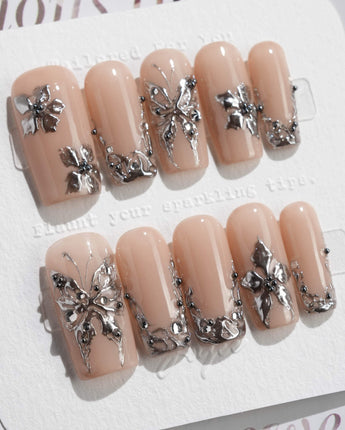 Chrome Rebellion press-on nails in medium square shape — Nude, 3D Silver Butterflies & Liquid Metal.