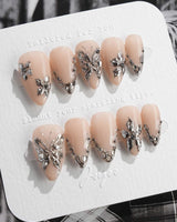 Chrome Rebellion press-on nails in short stiletto shape — Nude, 3D Silver Butterflies & Liquid Metal.